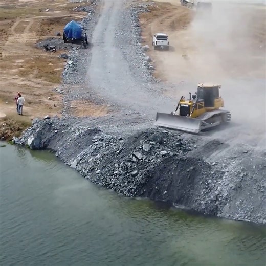 From Start to Finish: Boodozer and Dump Truck pushing rouck to fill in big lake #excavator #catexcavator #constructionsite #constructionlife #heavyequipment #machinery #caterpillar #demolition #operator #contractor #constructionworker #wheelloader #earthmoving #bulldozer #heavymachinery #heavyequipmentlife #hitachi #buldozer | Bulldozer Hub