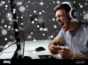 man in headset playing computer video game at home Stock Photo - Alamy
