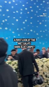 Take a look at the Met Gala's dark blue carpet. Lined with faux daffodils, the carpet is covered by a tent printed with petals and a starry sky. | AP