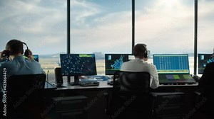 Diverse Air Traffic Control Team Working in a Modern Airport Tower. Office Room is Full of Desktop Computer Displays with Navigation Screens, Airplane Flight Radar Data for Controllers.