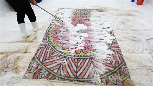 Foam spreading process reveals colorful pattern beneath dirt