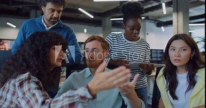 Camera focus on handsome Caucasian man with red hair and moustache. Male trying to explain something to work colleagues. People not agreeing. Difficulty in communication. Negative feedback.