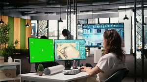 Real estate developer reviews project blueprints with chroma key in a corporate office, planning residential housing and property investment strategies for urban redevelopment. Camera A.