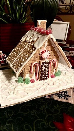 Family craft night making graham cracker gingerbread houses