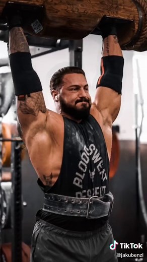 Strongman Lifts Heavy Log with Impressive Strength