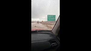 Vehicles navigate flooded roads in Chile after heavy rain