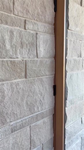 This front door is set in stone... literally 💪. This hinged front door is seamlessly set within stone, showcasing the harmony of natural materials and modern design. @plaadoffice definitely created an entrance that commands attention. #AndersenWindows #FrontDoor #HingedDoor