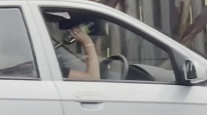 Drink driver allegedly caught skolling wine bottle behind the wheel