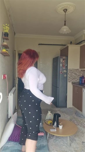Dancing Woman in Stylish Kitchen Setting