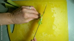 Man dicing celery with knife. Top down angle