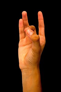 Isolated hand of a male teenage boy doing Shuni or Shoonya Yoga Mudra...