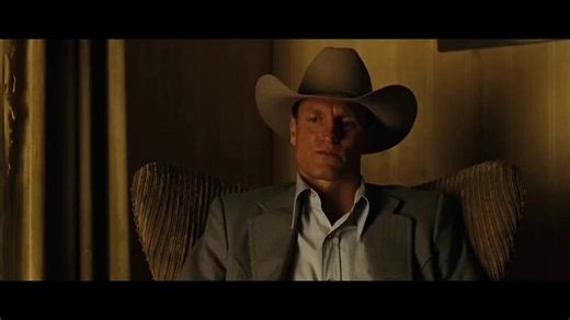In No Country for Old Men (2007), the hotel room scene is pure dread. Two men sitting in chairs, barely moving, and you watch one of them slowly realize he’s already dead.