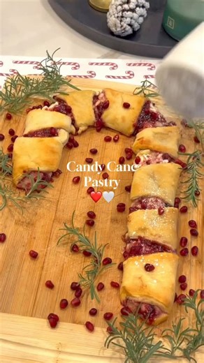 3 Ingredient Candy Cane pastry is so delicious and easy! ❤️🤍 All you need is~ 1 pkg crescent rolls 1 8 oz cream cheese softened Raspberry jam Unroll the crescent rolls on a baking sheet in the shape of a candy cane. Spread the softened cream cheese on to the crescent rolls. Then spoon the raspberry jam over top. Bake at 350° for about 10 minutes. Garnish with powdered sugar, rosemary, and pomegranate seeds. #candycanepastry #crescentrolls #christmasbreakfast #christmasfood #holidayfood #christm