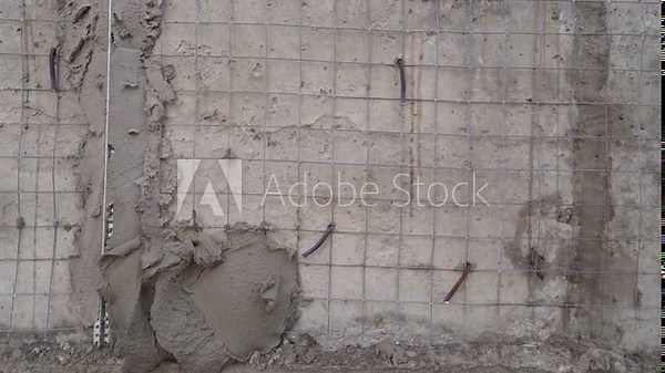 The plaster is applied to the surface with a steel spatula. Decorative plaster based on white cement, resistant to external influences. Applying plaster to the outside of the building.
