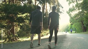 Two people walking in a park after running