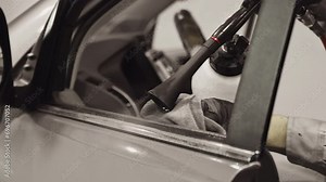 Professional Engineer Wearing Black Gloves Expertly Using Tornado Gun to Clean Car Window