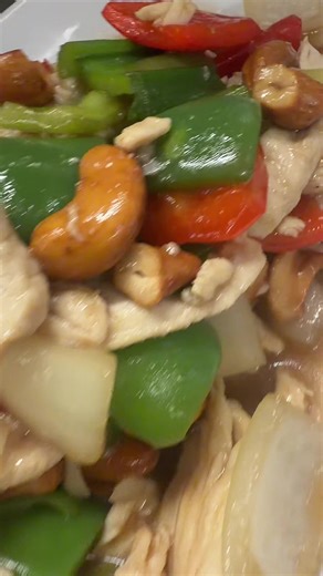 Thai Cashew Chicken (Gai Pad Med Mamuang) is a stir-fry featuring tender chicken, crunchy roasted cashews, and vegetables like onions and bell peppers in a glossy soy-oyster sauce. The dish is characterized by toasted cashews, dried chilies for a slight kick, and a sweet/salty balance, often served with rice. #thaifood #food #thaicuisine #simple #happy