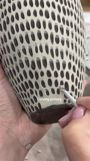 Carving through a layer of porcelain slip over dark clay. The contrast only works because the slip sets to leather-hard before cutting — firm enough to hold an edge, soft enough to reveal the body underneath. #pottery #ceramics #fyp #art #fypシ