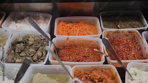 Close up view of salads made with cabbage and carrot and different vegetables that is on the sale in the market of Tel Aviv, Israel