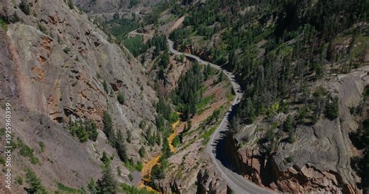 Aerial perspective of narrow mountain pass road winding along rugged Colorado cliffs, Million Dollay Highway Colorado USA