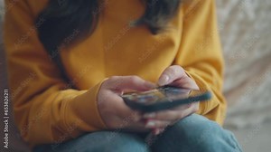 Finger of woman touching scroll page app on mobile phone. Browsing movie video in the internet library to watch film online.