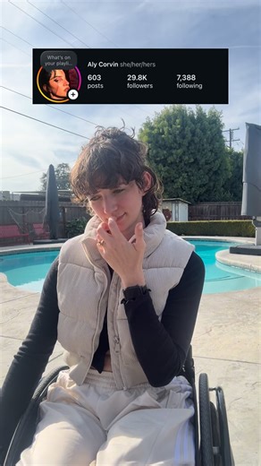 Aly Corvin on Instagram: "No words can even explain… how I feel… Alt text: a woman sits in a Wheelcahir and talks to the camera gesturing at a photo above her that has a follower count of 29.8k. Captions are on screen for accessibility. #Wheelie #Wheelchair #Shock #NewFollowers"