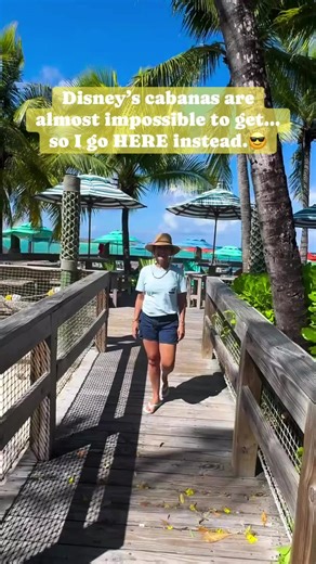 DCL 101 on Instagram: "Everyone stresses about getting a Castaway Cay cabana… and yes, they’re amazing — but here’s the secret: you absolutely do not need one to have a comfortable beach day. Right next to Cookies BBQ near Conched Out Bar there’s a shaded deck area with Adirondack chairs, colorful umbrellas, high-top tables, palm trees, and a constant breeze. It’s one of my favorite places on the island when I don’t book a cabana, and it stays surprisingly peaceful. And remember — so much is alr