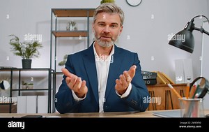 POV video screen view of businessman working at home office desk talk online communication video webcam call with employee, boss, colleague. Mature man freelancer support services looking at camera Stock Photo - Alamy