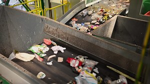 Garbage Being Transported on Trash Conveyors Inside Sorting and Recycling Facility. Urban Waste Management Theme.