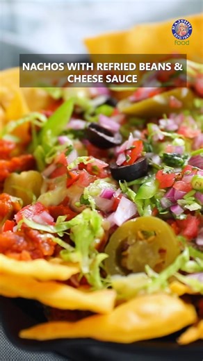 Forget takeout! Learn How to Make the Ultimate Nachos right in your own kitchen with this easy recipe. Watch the entire recipe on our Rajshri Food YT Channel. Host: Chef Ruchi Bharani Nachos with Refried Beans Ingredients: How To Make Nacho Chips 1/2 cup Maize Flour 1/2 cup Plain Flour 2 Pinch Salt 2 Pinch Red Chilli Powder 2 Pinch Turmeric Powder 1 tbsp Oil Water How To Fry The Nacho Chips Oil (for frying) How To Make Refried Beans 2 tbsp Oil 1 Onion (chopped) 2 Garlic Cloves (chopped) 2 Tomato