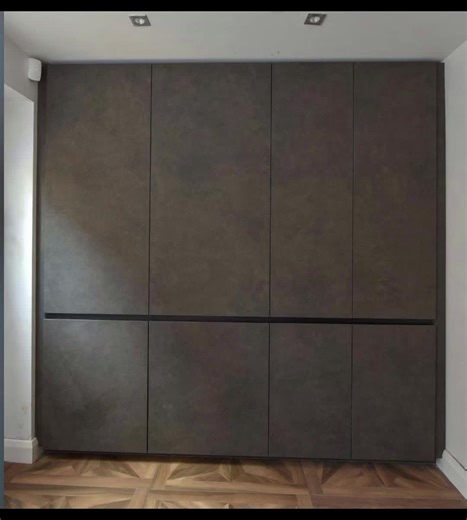 A whole laundry room hidden away behind doors, opening the tall doors to reveal a boiler with laundry storage below, stacked washer & dryer and storage for a plug in vacuum #laundryhack #laundryday #utilityroom #design #laundryroomideas