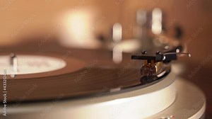 finger presses the button on the turntable and the neck of the turntable rises from the record