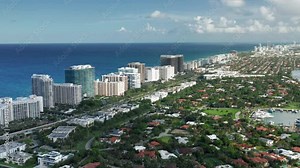 4K aerial view of clean deep blue sea waters. Bird-eye view on the residential front line buildings with beautiful Atlantic ocean view. South Beach tropical nature at day time, Florida, USA