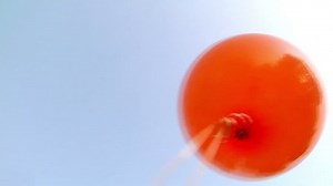 Balloons are let go and float away into space and behind DV NTSC video