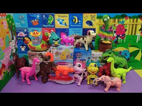 A collection of battery-operated animals: elephant, horse, cow, buffalo, dinosaur, fish, and dog.