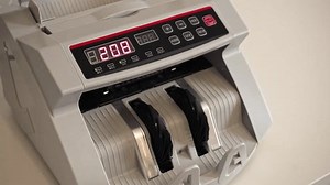 clip-3701761969-currency-counting-machine-use-business-setting-displaying