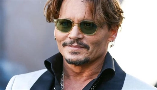 Johnny Depp appears to be a true rock star as he performs in Manchester