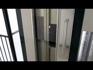 Two Schindler elevators with blue light
