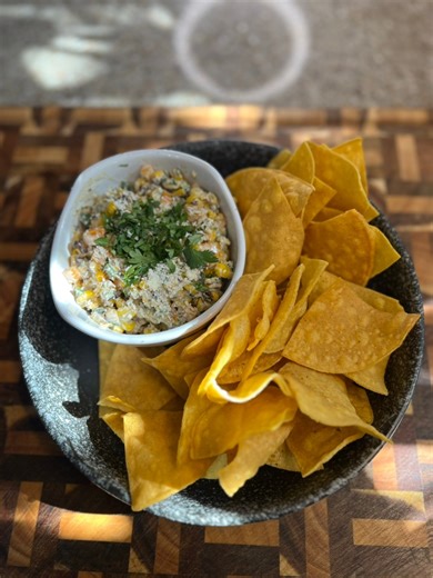 Chips & Corn Salsa! Yellow Corn Tortillas - 48 Salt Mango Habanero Seasoning Canola Oil Birds Eye Fire Roasted Corn - 4 bags Bell Pepper - 2 Red Onion - 1 (small) Jalapeño - 4 (deseeded) Cilantro - 1 bunch Cotija Cheese - use your heart Mayo - 1c Sour Cream - 1c Lime Juice and Zest - 2 Salt Chili Lime Seasoning Directions: 1. Add the bags of frozen corn to baking sheets and heat up at 400 degrees for 5-8mins until warmed through. 2. Finley dice the bell peppers, jalapeños and red onion. Add to a