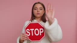 Serious adult woman say No, hold inscription text red No stop danger...