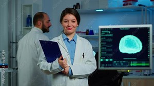 Portrait of scientist neurologist researcher looking at camera smiling while coworker discussing with patient in background about brain functions, nervous system, tomography scan working in laboratory