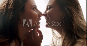 The women approach each other, touch each other tenderly and romantically. sweet kiss. Close up look at face. Embrace and holding each other. Love and kiss, LGBT rights, Lesbian family. LGBT concept