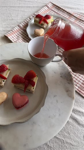 Cera Ruby on Instagram: "My girls love a tea party! Everything below to make your own Valentine’s Day Tea Party at home! Menu: Tea Sandwiches Macarons Pink Lemonade For Valentine’s Day: Cucumber Tea Sandwiches w/ Strawberry Bows, Pink Lemonade in a Tea Cup, Heart Shaped Vanilla and Raspberry Macarons. How to make tea party sandwiches: Our favorite is cucumbers thinly sliced and cream cheese tea sandwiches. 1. Spread cream cheese on bread 2. Add cucumber slices 3. Top with second piece of bread a
