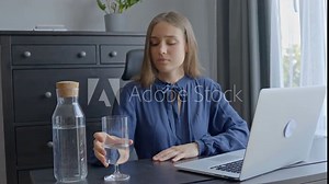 Importance of staying hydrated when working in office at laptop