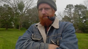 clip-1057901149-shot-bearded-ginger-mans-face-he-smokes