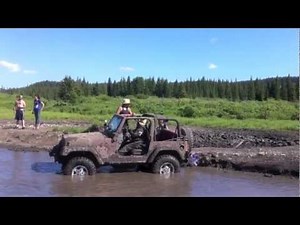 Bride wades through the mud in her wedding dress