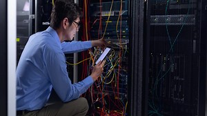 Video of asian it engineer using smartphone checking computer server | Premium Stock Video Footage