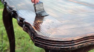 Final Coverage of the Restore Table/The cabinet maker varnishes the larch table Stock Video