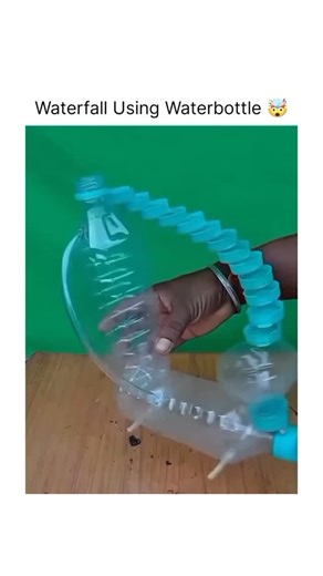 how stuff performs on Instagram: "DIY Waterfall Bottle Sculpture A short clip shows a handmade waterfall structure built from reused plastic bottles and caps. Colored water pours from the top and travels through a spiral chain of caps, falling smoothly all the way down. The creator invites others to try making the sculpture themselves as a fun recycling project. The design works through gravity — the water simply flows downward until it reaches the bottom container. It looks continuous, but it i