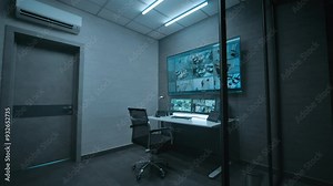View on the workplace for surveillance operator or dispatch in dark modern monitoring room. CCTV video footage from office security cameras on computer monitors, tablet display and big digital screen.